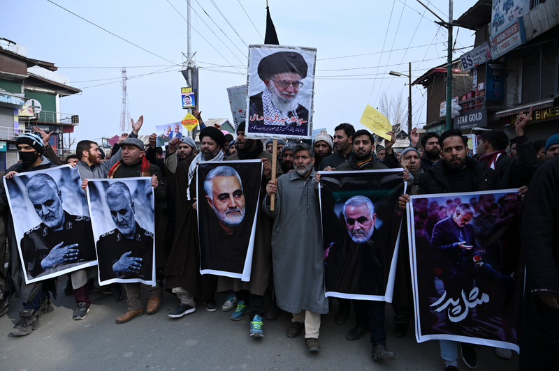 Protesters shout slogans against the United States and Israel as they hold posters with the image of top Iranian commander Qasem Soleimani, who was killed in a US airstrike in Iraq, and Iranian President Hassan Rouhani during a demonstration in the Kashmiri town of Magam on January 3, 2020.